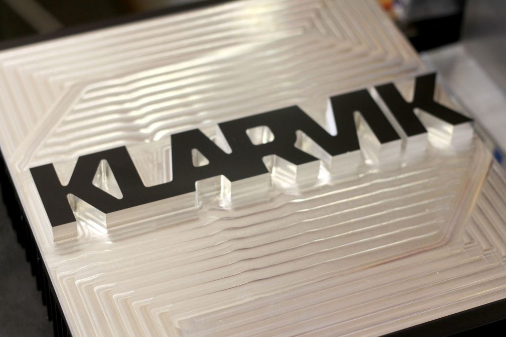 Fr&auml;st aluminiumskylt med Klarvik-logotyp som visar precision i bearbetning.